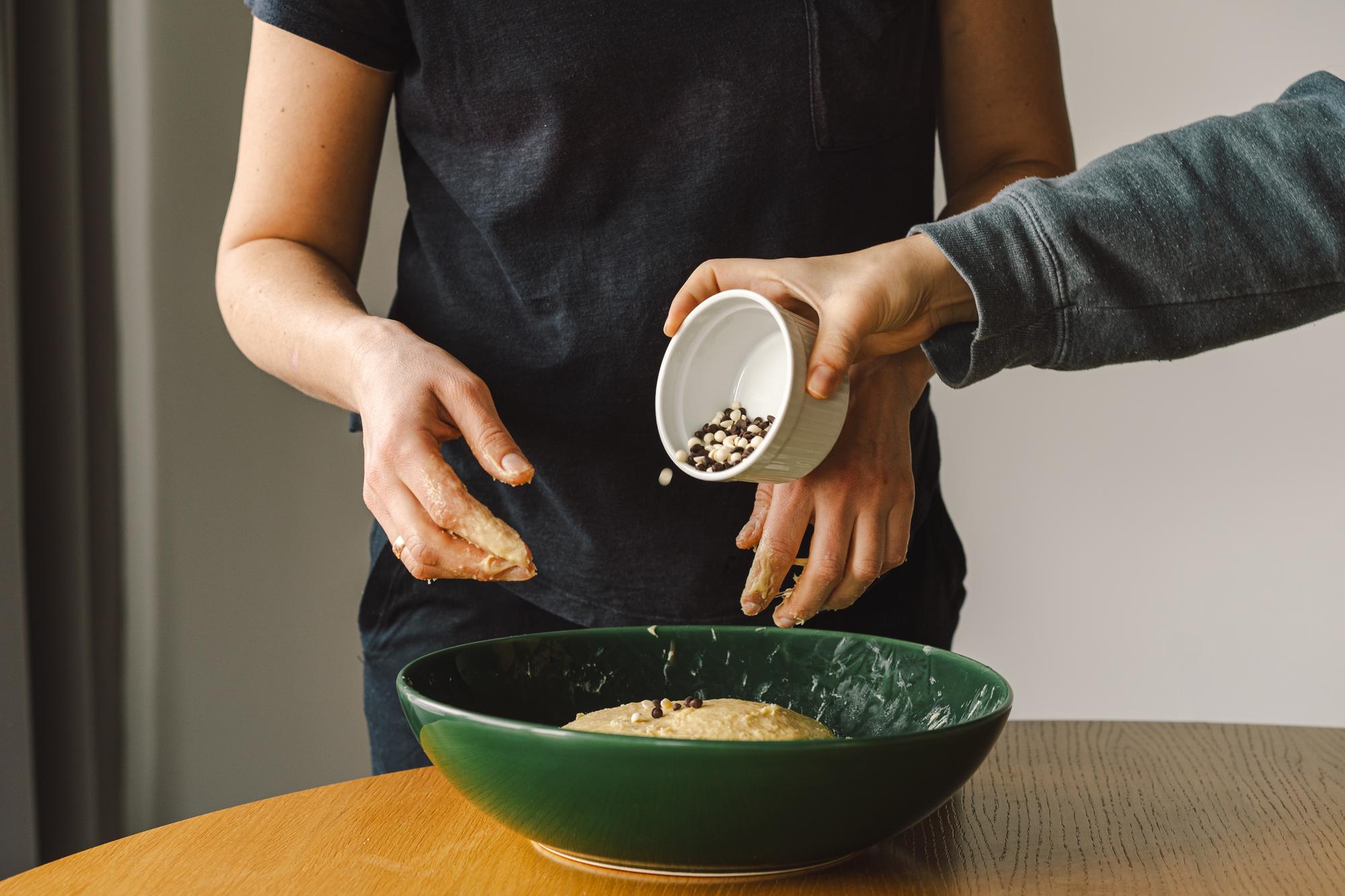 Hands seasoning a bowl in studio kitchen